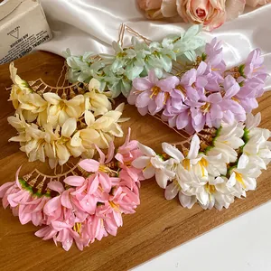 Detailed view of several colorful fabric flower hair pins in a vintage Chinese style