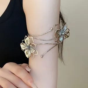 Detailed view of an elegant metallic upper arm cuff featuring pleated floral designs