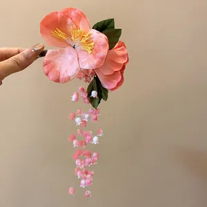 Handcrafted pink flower hair clip with dangling lily of the valley tassels for Hanfu style.