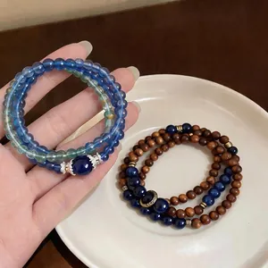 Elegant stackable stone and dark wood beaded bracelets with vintage ethnic design for women