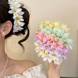 Detailed view of pastel floral hairpins on model for a sweet Chinese style look.