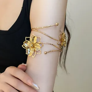 Detailed view of a gold metallic floral arm cuff wrapped elegantly on the upper arm