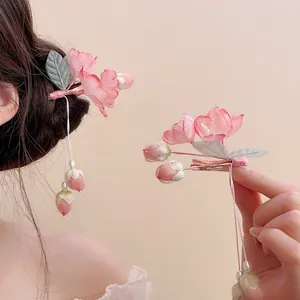 Detailed shot of pink floral tassel hair clip, elegant accessory for traditional Hanfu.