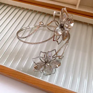 Elegant silver metal arm cuff bracelet featuring a detailed pleated flower design