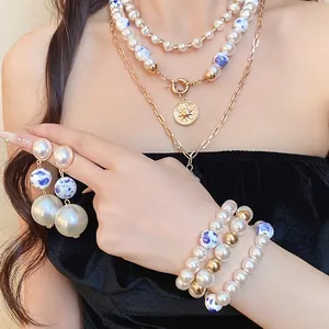 Vintage multi-layer pearl necklace set with sun pendant, ceramic beads, and matching jewelry