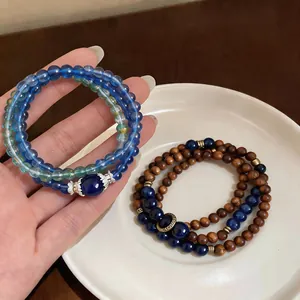 Close-up of retro ethnic style bracelets with blue stone beads and brown wood beads