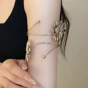 Detail of silver wrinkled flower arm cuff showing intricate sunflower petals on upper arm
