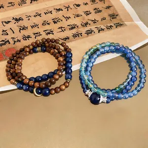 Close-up of vintage multi-layer bracelets featuring natural wood and blue stone beads