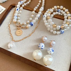 Detailed view of vintage jewelry set featuring ceramic pearls and gold beaded accents