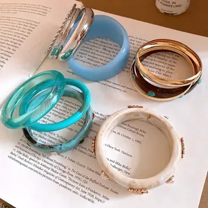 Collection of vintage resin and metal bangles in bohemian style for artistic summer fashion