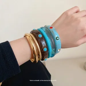 Set of bohemian stackable resin bangles in vintage brown and turquoise blue