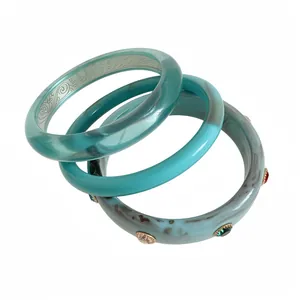 Set of three vintage resin bangle bracelets in turquoise and marbled blue.