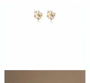 Close-up detail of stylish pink star pearl stud earrings with elegant gold finish