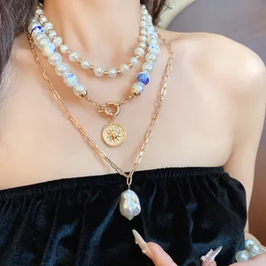 Close-up of vintage multi-layered ceramic pearl necklace featuring a golden sun coin pendant
