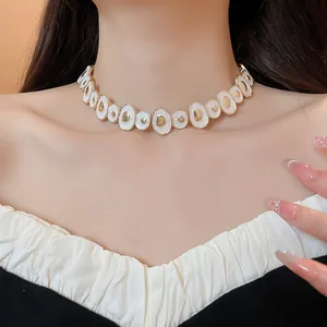Detail view of a vintage white enamel irregular round choker necklace on model's neck