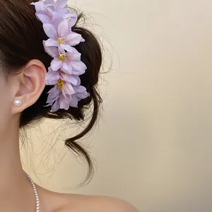 Detailed close-up of delicate lavender flower hair clip on a stylish bun hairstyle