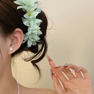 Elegant detail of a light blue flower hair pin used in a bun for new Chinese style