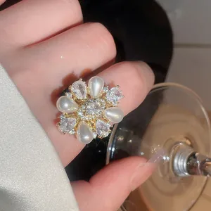 Exquisite Nahaufnahme eines floralen Perlen- und Zirkonia-Rings an einem Damenfinger