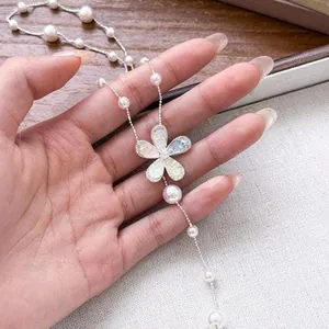 Elegant zircon flower pendant necklace featuring white pearls, perfect for women's jewelry.