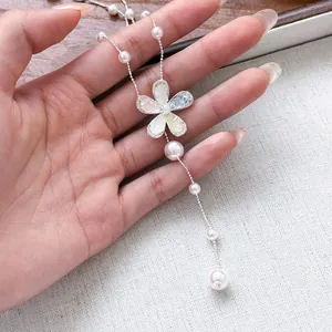 Elegant silver-tone necklace with zircon flower pendant and lustrous white pearls