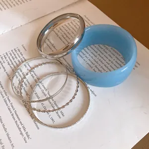 Detailed view of assorted resin and metallic vintage style bangles on an open book