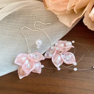 Detailed view of elegant pink petal earrings featuring zircons pearls and tassels