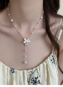 Elegant detailed view of zircon flower pendant necklace with white pearl beads