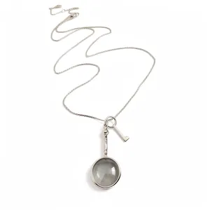 Elegant vintage silver necklace with circular magnifying glass and key charm pendants