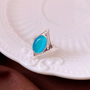 Vintage silver open ring featuring a large oval blue cat's eye stone in geometric setting