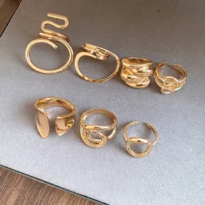 Set of minimalist gold-plated abstract rings with winding hollow designs for women