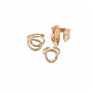 Set of three abstract oval and cross-wound hollow rings with a polished rose gold finish.