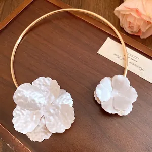 Luxurious minimalist gold metal neck ring featuring two elegant white textured flower charms