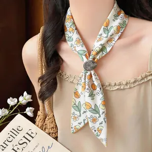 Close-up of floral print fabric choker with a vintage metallic ring buckle detail.