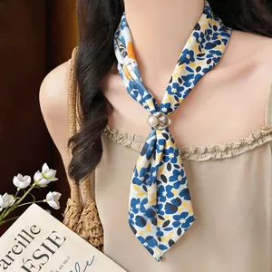 Close-up view of resort style floral fabric necklace with a pearl resin buckle detail