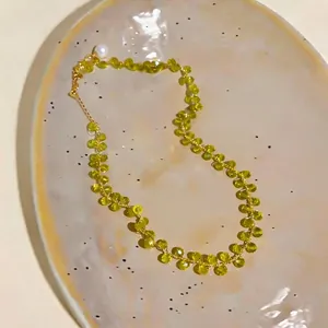 Elegant 14k gold plated beaded necklace featuring green crystals and a pearl pendant