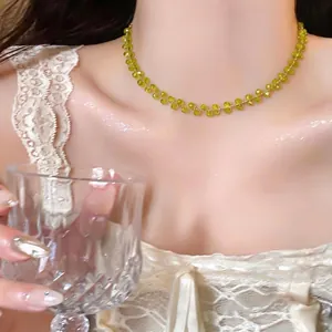 Elegant 14k gold plated beaded choker necklace with translucent yellow-green gemstones on model