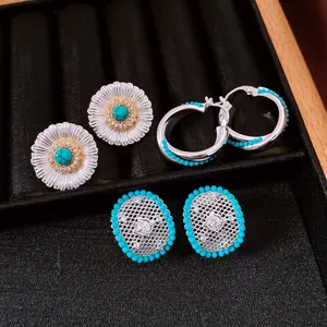 Detailed view of vintage silver earrings set featuring turquoise and hollow mesh designs