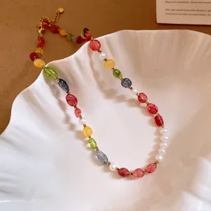 Detail of colorful stone and pearl beaded necklace on shell tray.