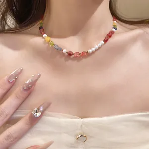 Handcrafted colorful stone and pearl beaded necklace detail shot on model neck