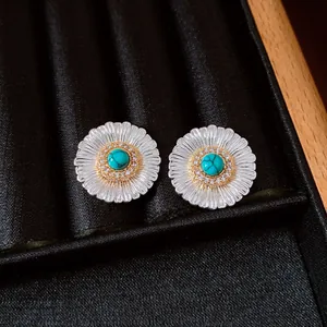 Detailed close-up of vintage flower earrings with turquoise and zircon