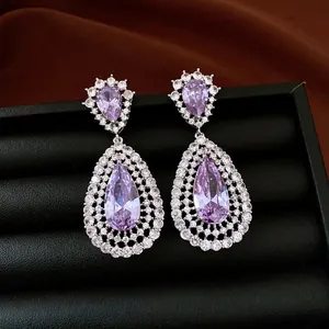 Luxury silver needle dangle earrings featuring lavender teardrop zircons and intricate hollow metalwork