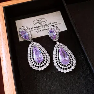 Elegant silver drop earrings with pear-shaped purple zircon stones in a luxury box