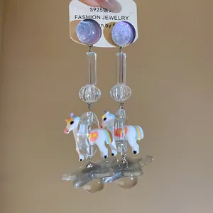 Detailed macro view showing the whimsical resin unicorn and star dangle earrings charms