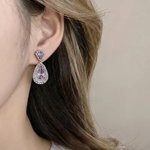 Elegant zircon water drop hollow dangle earrings on model for luxury fashion look