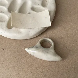 Detailed macro view of a unique marble patterned resin ring with chunky oval shape