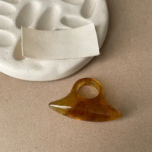 Macro view of a minimalist amber resin ring with unique oval sculptural design
