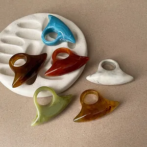 Unique curved resin rings featuring diverse marble textures and vibrant colors for a niche look
