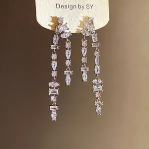 Sparkling silver needle tassel earrings featuring geometric cubic zirconia stones