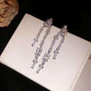 Elegant silver tassel earrings with sparkling square cubic zirconia on a white display box