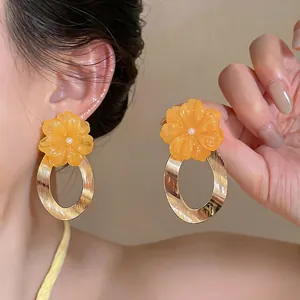 Elegant orange resin flower earrings with gold textured oval hoop dangles for women